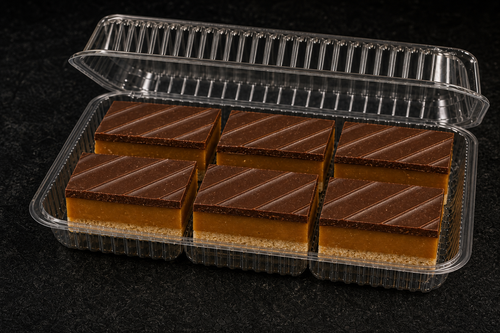 Presentation concept showing finished caramel slices in clear clamshell packaging