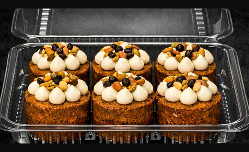 Presentation concept showing six individual carrot cakes in clear clamshell packaging